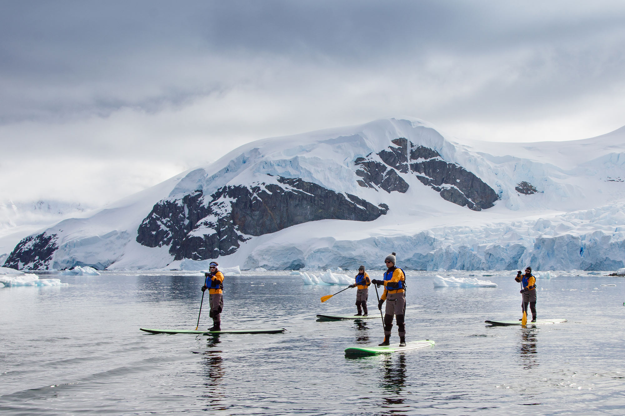 Passengers Stand-up Paddleboarding in the Antarctic