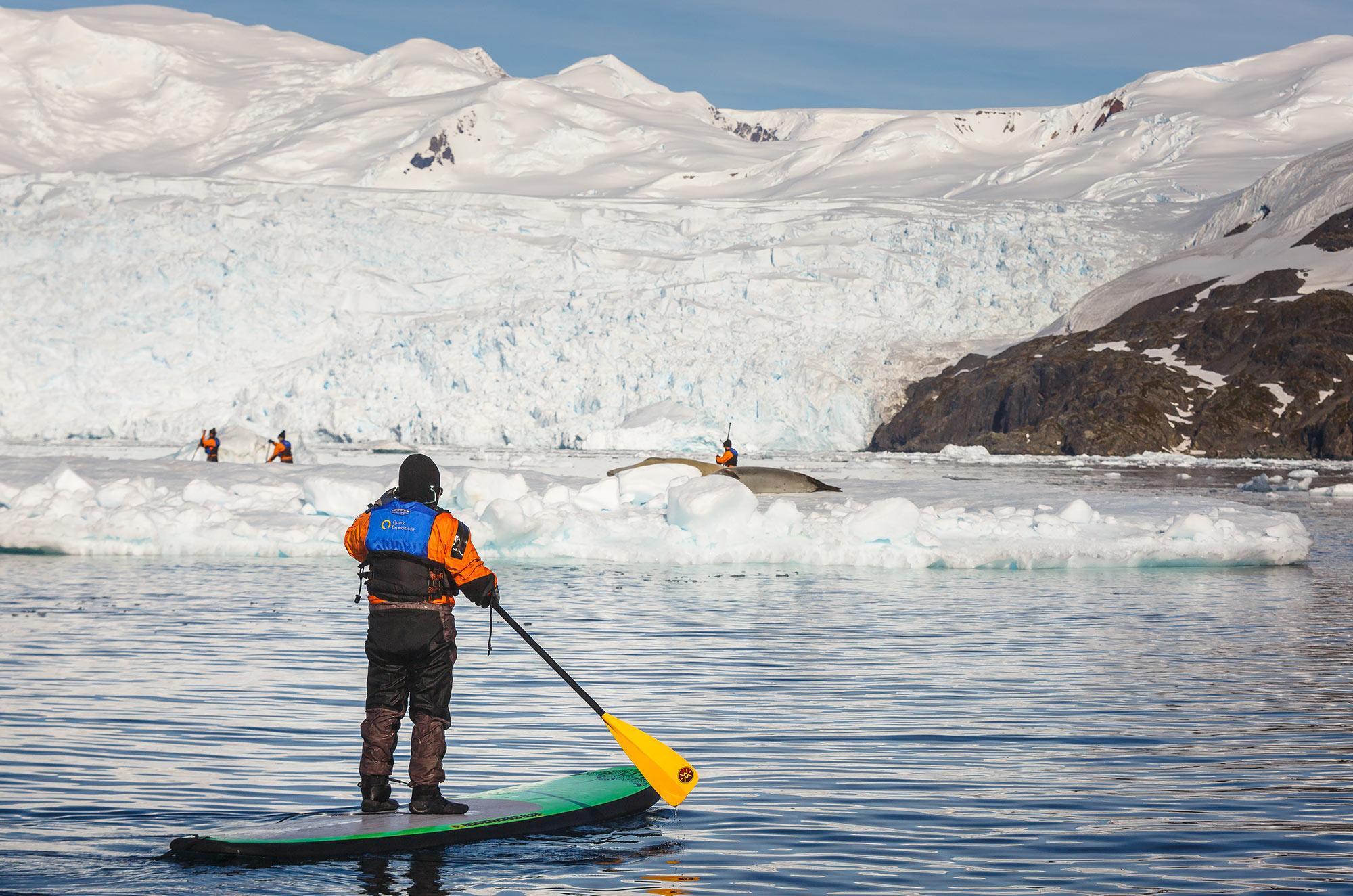 Passengers Stand-up Paddleboarding in the Antarctic