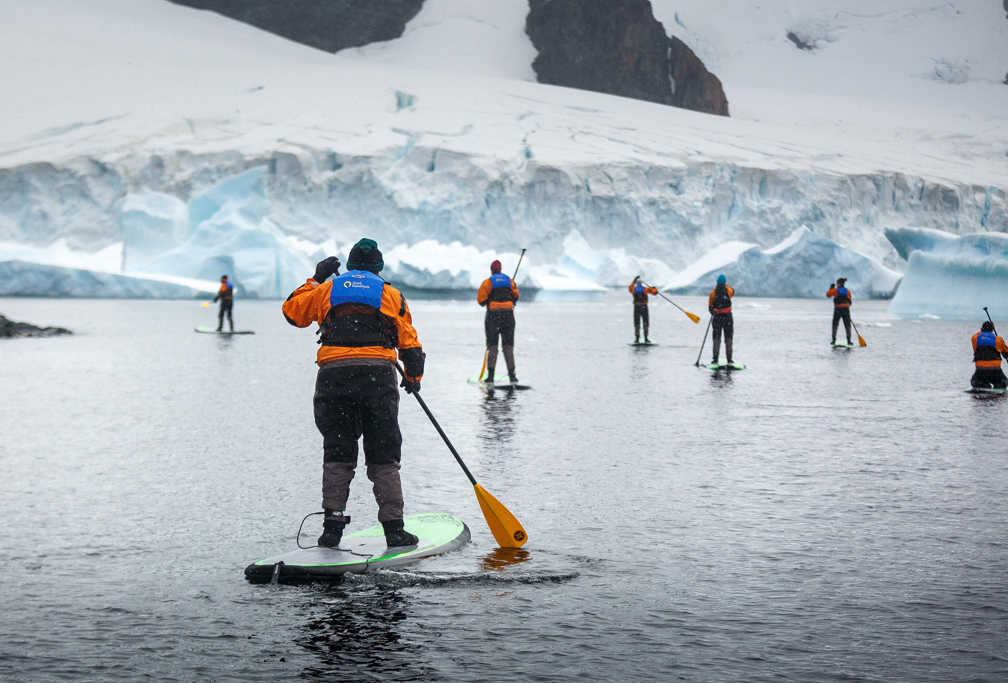 Passengers Stand-up Paddleboarding in the Antarctic