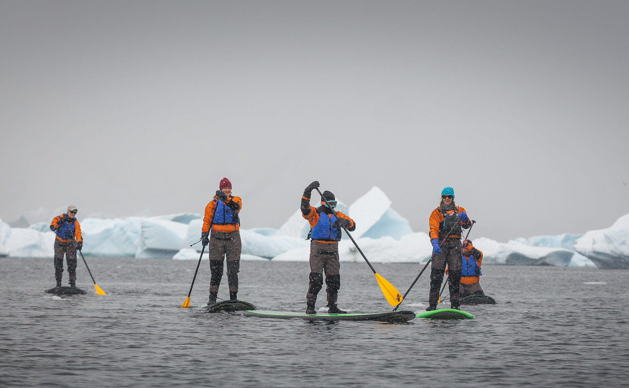 Passengers Stand-up Paddleboarding in the Antarctic