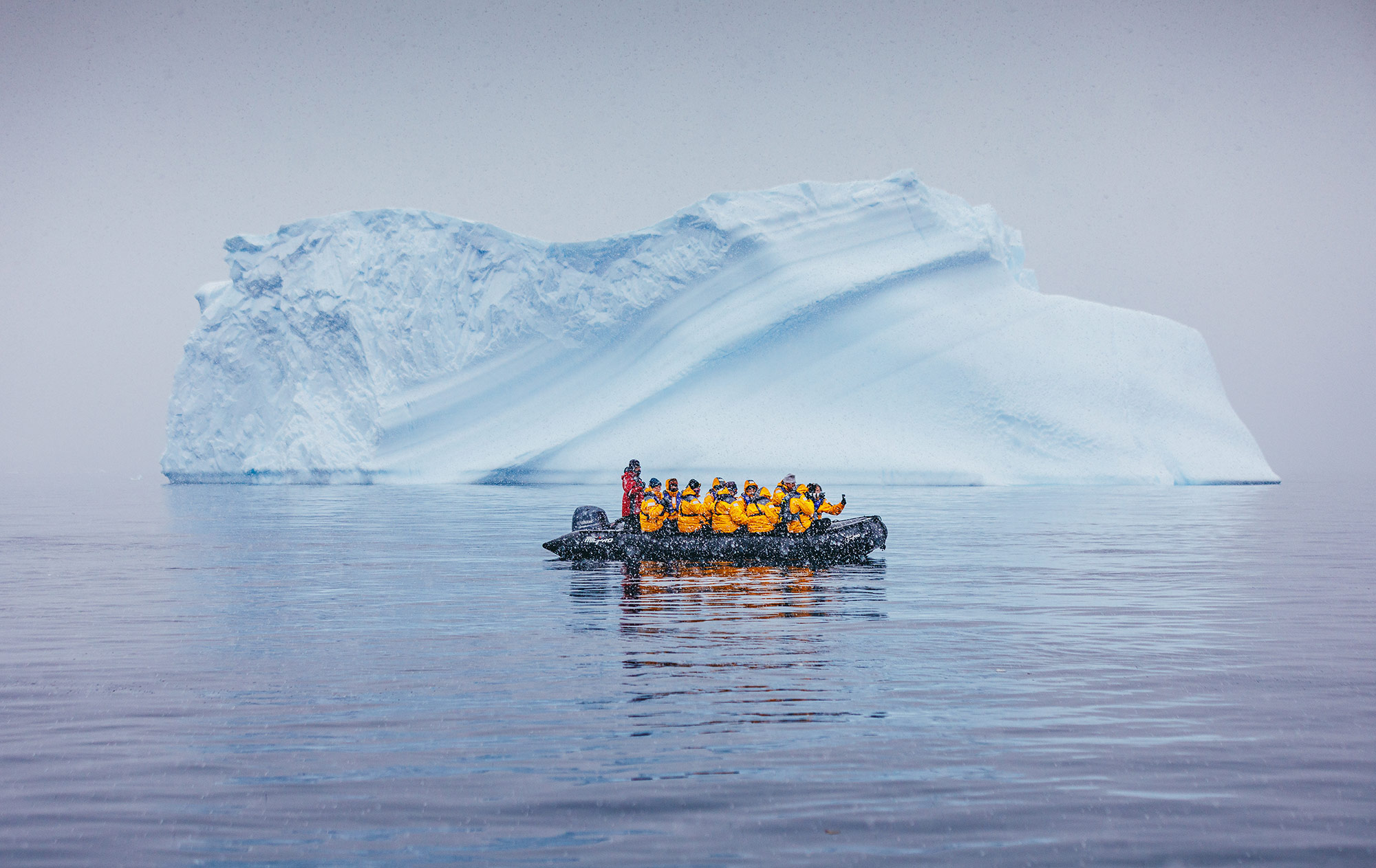 Zodiac cruising infront of an iceberg