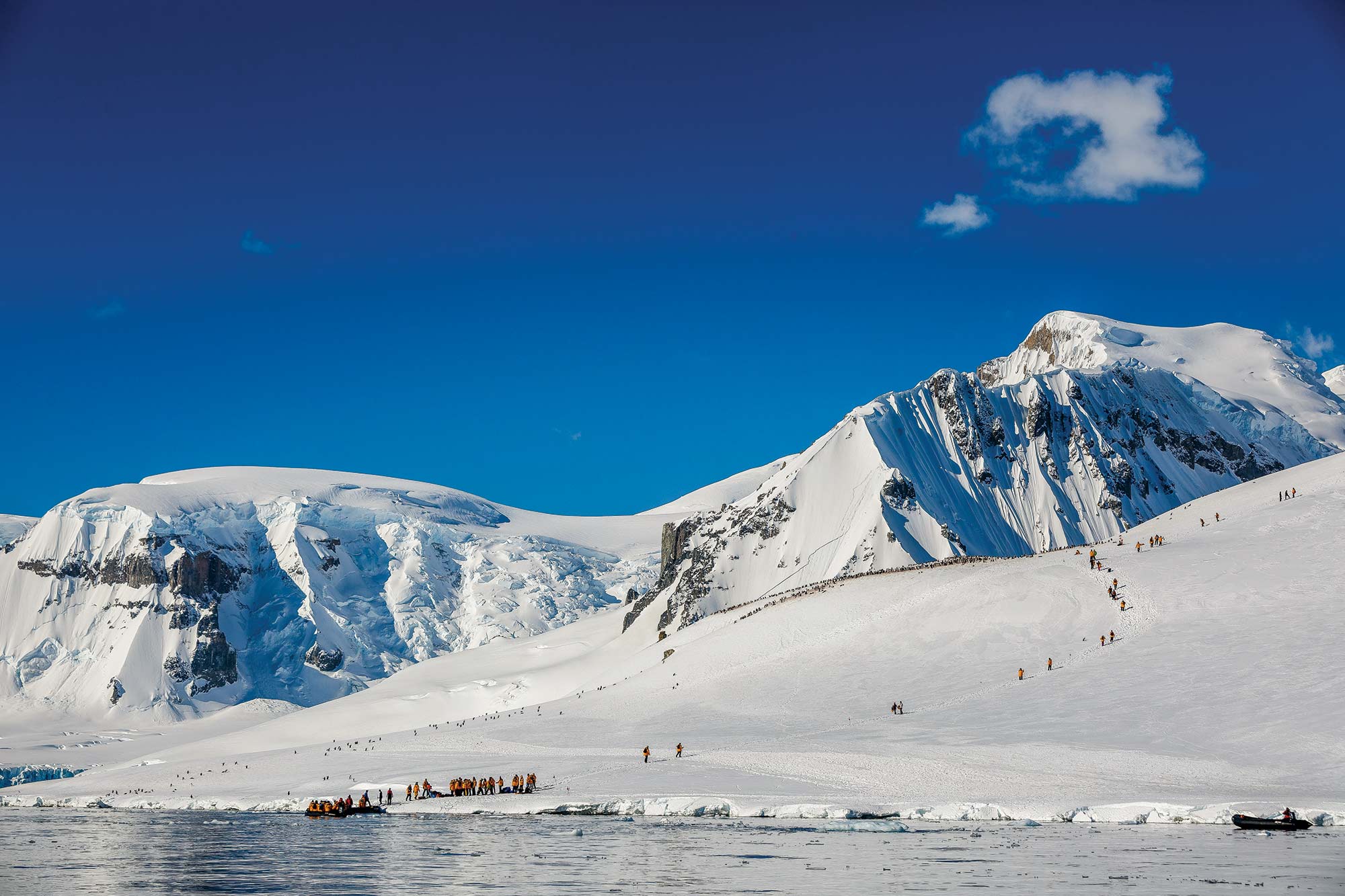 Passengers exiting Zodiac and hiking in the Antarctic